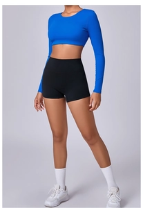 Detail showing elastic compression fabric texture on blue long sleeve yoga top and shorts