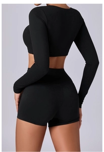 Back view of black slim-fit long sleeve top and high-waisted shorts showing athletic shape
