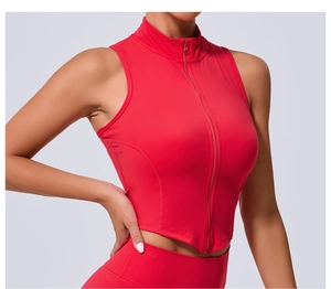 Dettaglio del gilet rosso con collo alto e orlo asimmetrico su modella sportiva