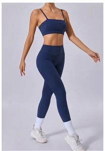 Detail view of navy blue high-waist yoga leggings and thin strap sports bra set