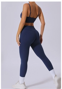 Detail view of the back showing a navy blue sports bra and high-waisted yoga leggings