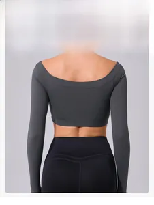 Detail view of the deep charcoal yoga crop top with U-shaped open back and slim fit design