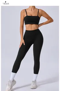 Detail view of black high-waisted yoga leggings and sports bra with thin straps