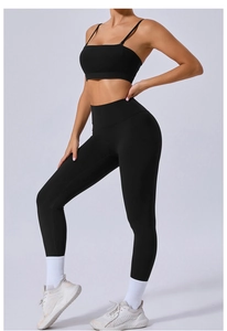 Detail view of high-stretch black two-piece yoga set with detachable straps and leggings