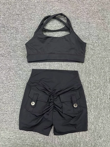 Détail d'un ensemble de sport noir avec soutien-gorge croisé et short taille haute froncé