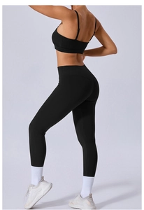 Detail of high-waisted black yoga set leggings and sports bra with cross-back design