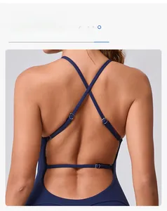 Detail of adjustable criss-cross straps on deep blue open back yoga bodysuit
