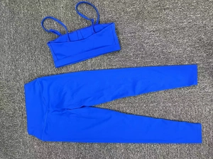 Flat lay detail of bright cobalt blue yoga set with sports bra and high waist leggings