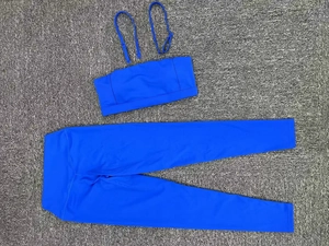 Flat lay of royal blue yoga set with sports bra and high-waisted leggings