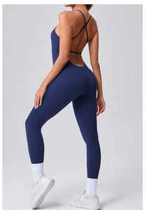 Detail of cross-back adjustable straps on deep blue compression yoga bodysuit