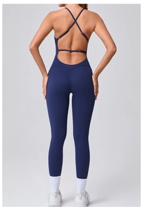 Close-up of cross back straps on a navy blue backless yoga jumpsuit for women