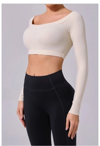 Detail view of the fitted off-shoulder yoga top and high-waist black leggings