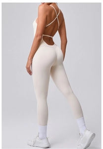 Detail of cross straps and back cutout on the cream compression fitness bodysuit