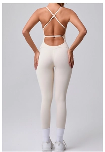 Detail of cross-back adjustable straps on a seamless light beige yoga bodysuit