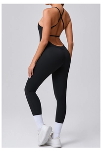 Close-up of black backless yoga bodysuit with crisscross straps and slim fit silhouette