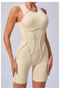 Detailed view of beige one-piece yoga romper featuring ergonomic contrast stitching