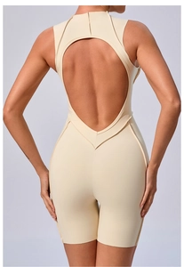 Detail view of beige yoga jumpsuit showing the back heart-shaped cutout and slim fit design