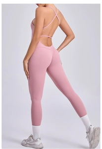 Detail of pink backless yoga bodysuit with cross-straps and peach-lift sculpting fit