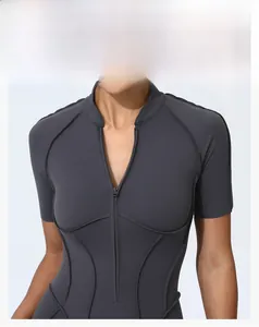 Detail of dark grey yoga bodysuit featuring stand collar, half-zip and elastic stitching