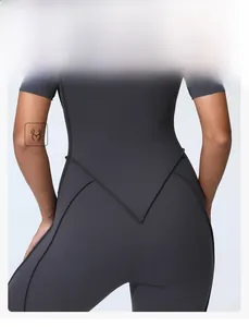 Detail view of V-shaped back stitching and body-sculpting seam on dark gray yoga bodysuit
