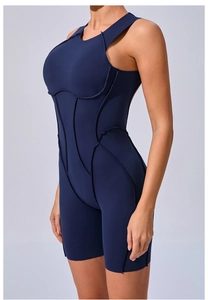 Detail of navy blue yoga bodysuit featuring contouring contrast stitching and high-stretch fabric