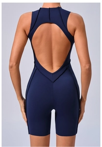 Detail of tear-drop cutout back and slimming seam lines on a navy compression yoga bodysuit
