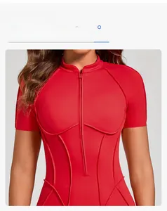Detail of red sports bodysuit featuring a front zipper and wrap-around seam structure
