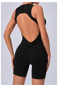 Detail view of backless black yoga bodysuit with deep V-cut and cross seams