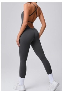 Detail of cross-back straps and open back design on a dark gray yoga unitard