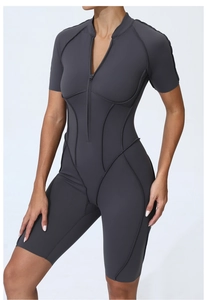 Close-up of dark grey fitness bodysuit with zipper and contouring curve stitch details