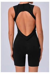 Detail of female sports bodysuit featuring deep back cutout and premium black fabric