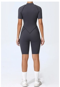 Detailed back view of charcoal grey fitness romper with V-shaped contour stitching