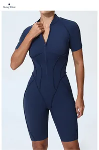 Detail view of navy blue athletic short sleeve jumpsuit with ergonomic waist stitching