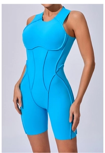 Detail of light blue yoga jumpsuit featuring structured piping and a slim-fit silhouette