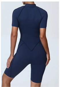Macro view of seamless V-shaped stitching on the back of navy blue yoga jumpsuit