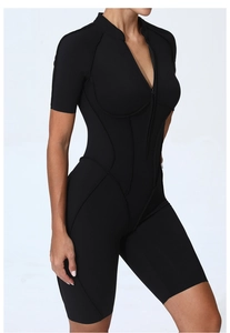Detail shot of black short sleeve yoga bodysuit featuring a front zipper and flatlock seams