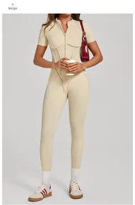 Detail view of beige short-sleeve yoga bodysuit with zipper and sculpting seams