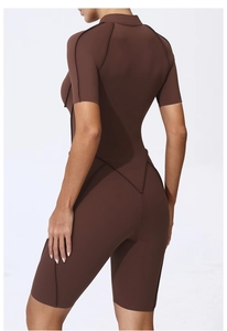 Detail view of brown athletic bodysuit featuring zipper back and V-line stitching details