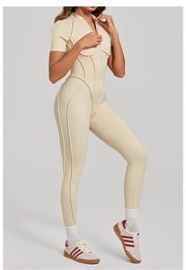 Detail of beige short sleeve yoga jumpsuit with stand collar and half-zipper design