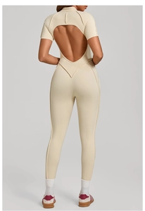 Back view of apricot open-back yoga bodysuit showing V-seam shaping and cut-out details