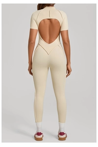 Back view of beige short-sleeved yoga jumpsuit featuring a stylish cutout design and fit