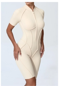 Close-up of beige short sleeve yoga bodysuit with front zipper and slimming stitching