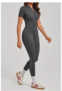 Detail view of the stitching and zipper on a dark gray short sleeve yoga bodysuit