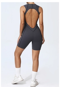 Detail of the open back design on a dark grey athletic romper with sculpting fabric