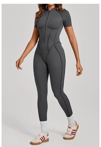 Detail of grey short sleeve sports bodysuit with front zipper and contrast stitching