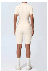 Back view of beige short sleeve sports bodysuit with V-shaped seam detail for yoga