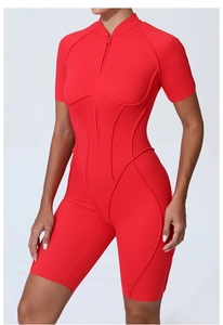 Detail of red athletic bodysuit showing front zipper, stand collar, and stitched contours