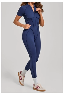 Close-up of high-stretch navy blue yoga bodysuit featuring a zip collar and ergonomic seams