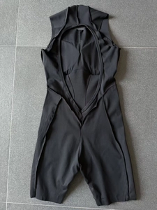 Detail view of black compression yoga bodysuit featuring open back and internal padding