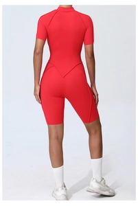 Detail view of red athletic bodysuit showing V-shaped waist stitching and stretch fabric